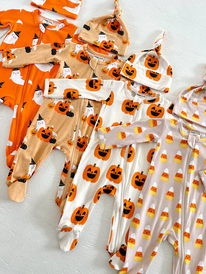 Colorful Halloween baby outfits with pumpkin and ghost designs, including hats in a playful arrangement.