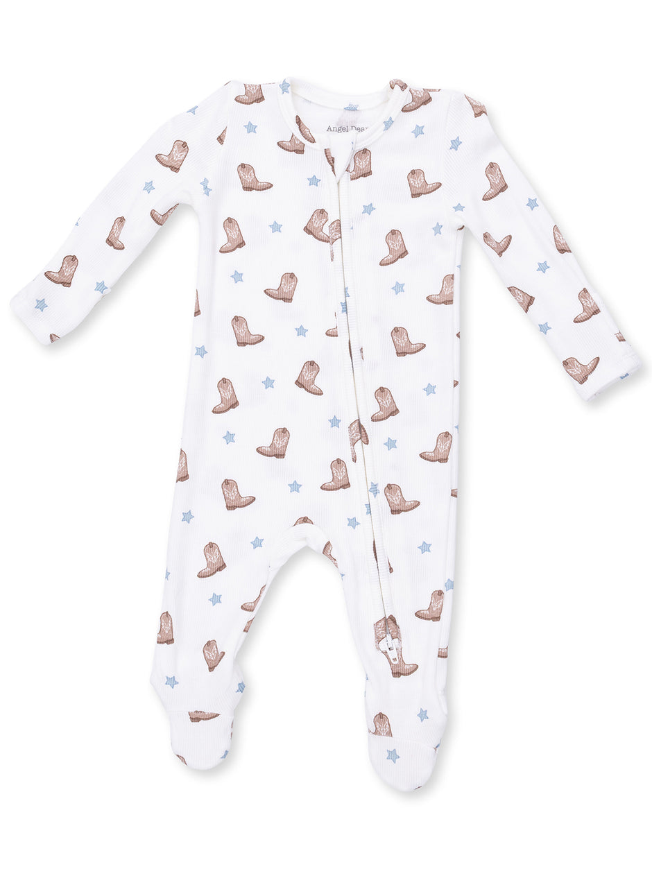 White infant onesie with brown cowboy boots and blue stars pattern, featuring long sleeves and a front zipper.