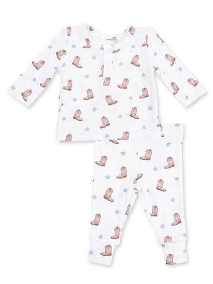 Cotton baby pajama set featuring an all-over cowboy boot and star pattern in neutral colors.