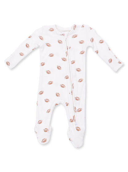 White infant onesie with football prints, featuring a front zipper and long sleeves.