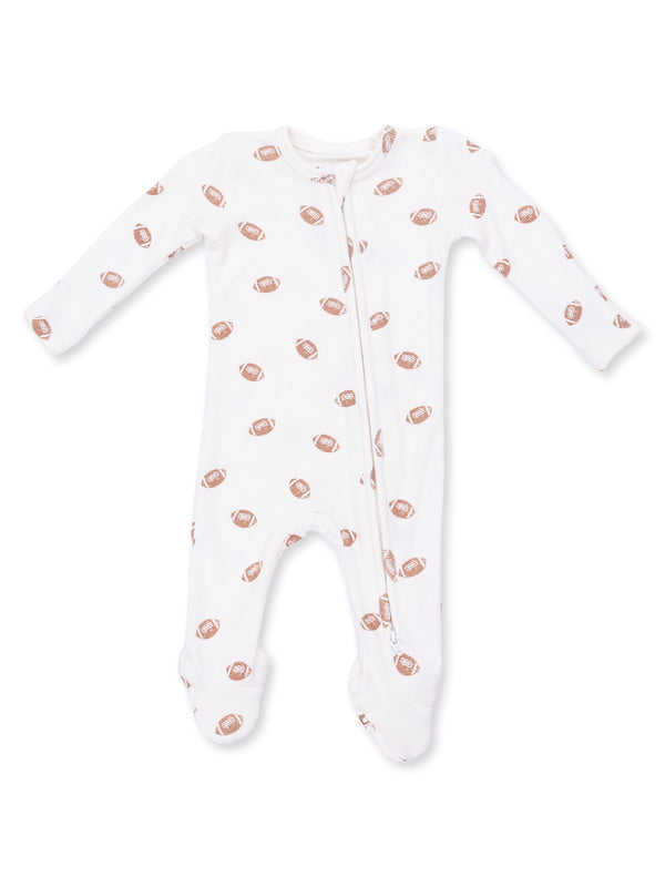 White infant onesie with football prints, featuring a front zipper and long sleeves.