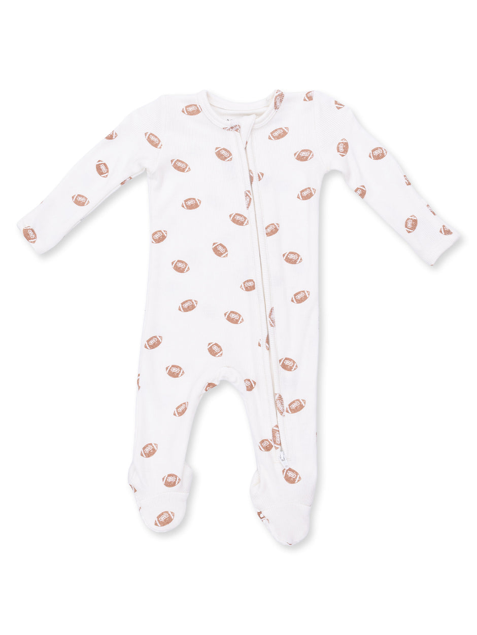 White infant onesie with football prints, featuring a front zipper and long sleeves.