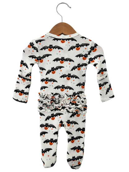 Halloween infant pajamas with bat and pumpkin prints, featuring ruffled design and long sleeves. 
