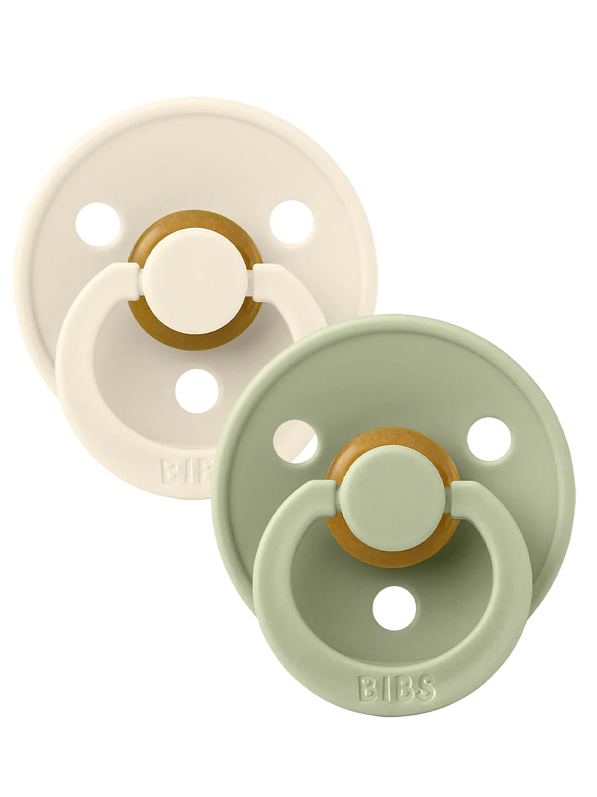 Two pacifiers, one in cream and one in sage green, both with round designs and a small handle.