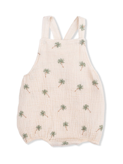 Light-colored baby romper with palm tree print and adjustable straps. Ideal for warm weather or casual outings.