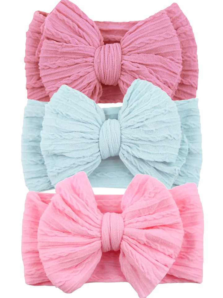 Three textured headbands in pink and blue with large bows. Ideal for infants and toddlers.
