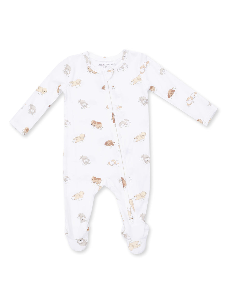 White baby onesie with long sleeves and a zipper, featuring a playful print of puppies.