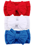 Three headbands in red, white, and blue, each featuring a large textured bow. Perfect for festive occasions.
