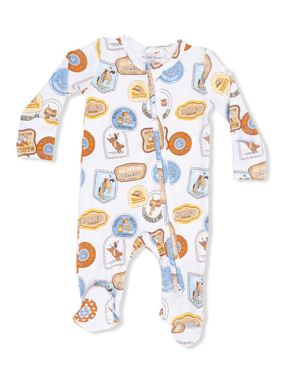 Cowboy-themed baby pajama with colorful patch designs, featuring rodeo and cowboy motifs on a white background.