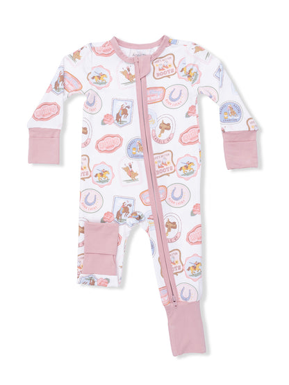 Child's rodeo-themed one-piece pajama with pink accents and playful graphics. Ideal for cozy sleepwear.