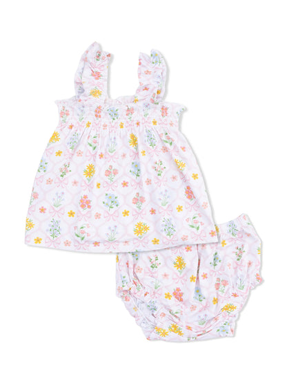 Floral baby outfit featuring a ruffled top and matching bloomers in pastel colors. Perfect for warm weather.