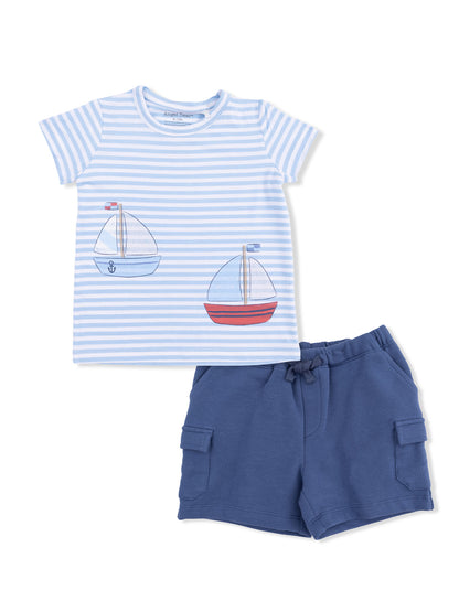 Striped children's shirt with sailboat designs and blue shorts, suitable for casual summer wear.