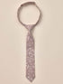Floral patterned tie hanging against a neutral background, showcasing delicate leaves and blossoms.