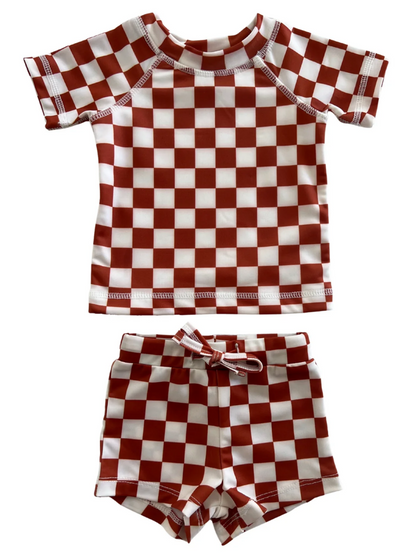 Red and white checkered short-sleeve rash guard set with matching shorts for children.