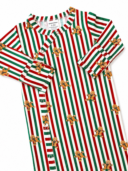 Red and green striped baby onesie with gingerbread man patterns. Ideal for festive occasions.