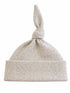 Light gray knotted baby hat with a soft, speckled texture and a folded cuff. Ideal for infants.