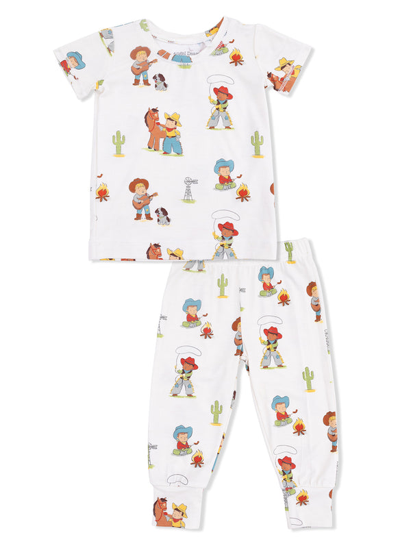 Children's pajamas featuring colorful cowboy and cowgirl illustrations on a white background.