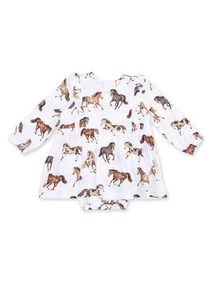White dress with horse patterns and long sleeves, featuring ruffles and a bottom snap closure.