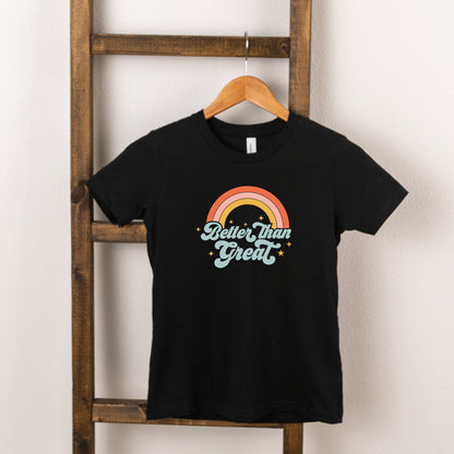Black t-shirt hanging on a wooden ladder, featuring a colorful rainbow graphic and the text "Better than Great."
